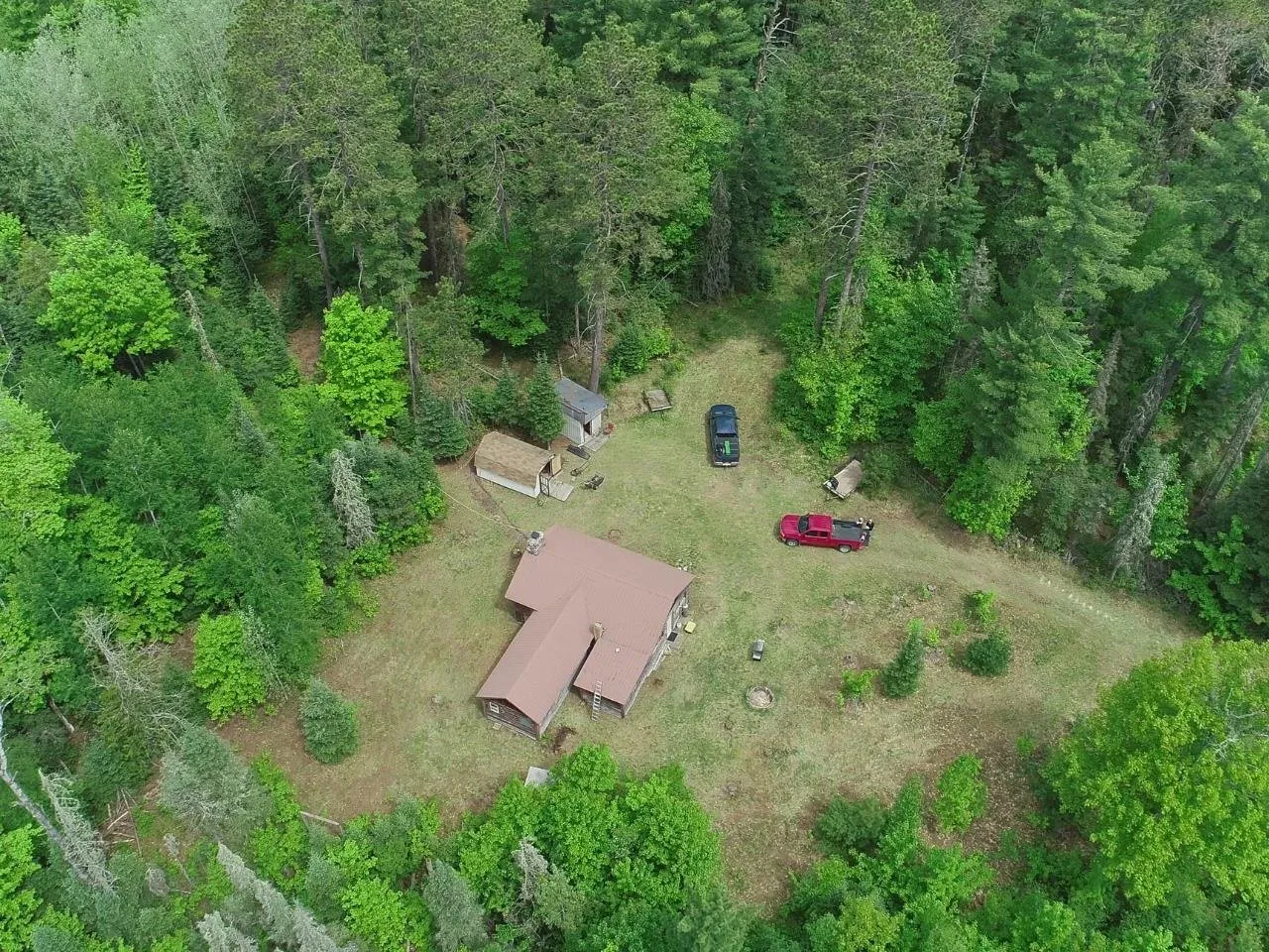 The camp and the mowed yard from high above the treetops