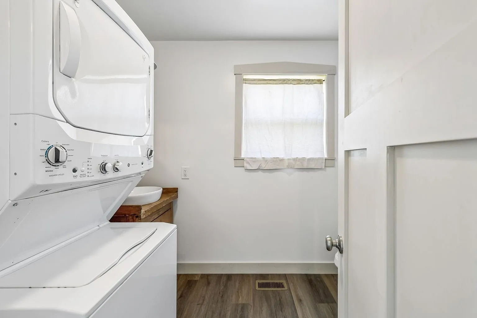 The laundry closet with the stacked washer and dryer