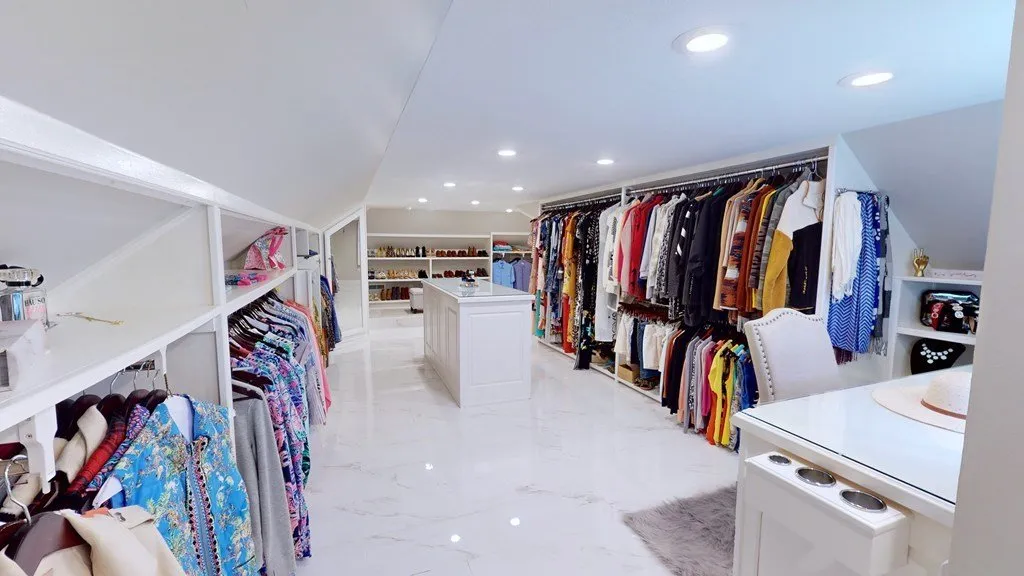 The closet's shelving wall with hanging space on both sides