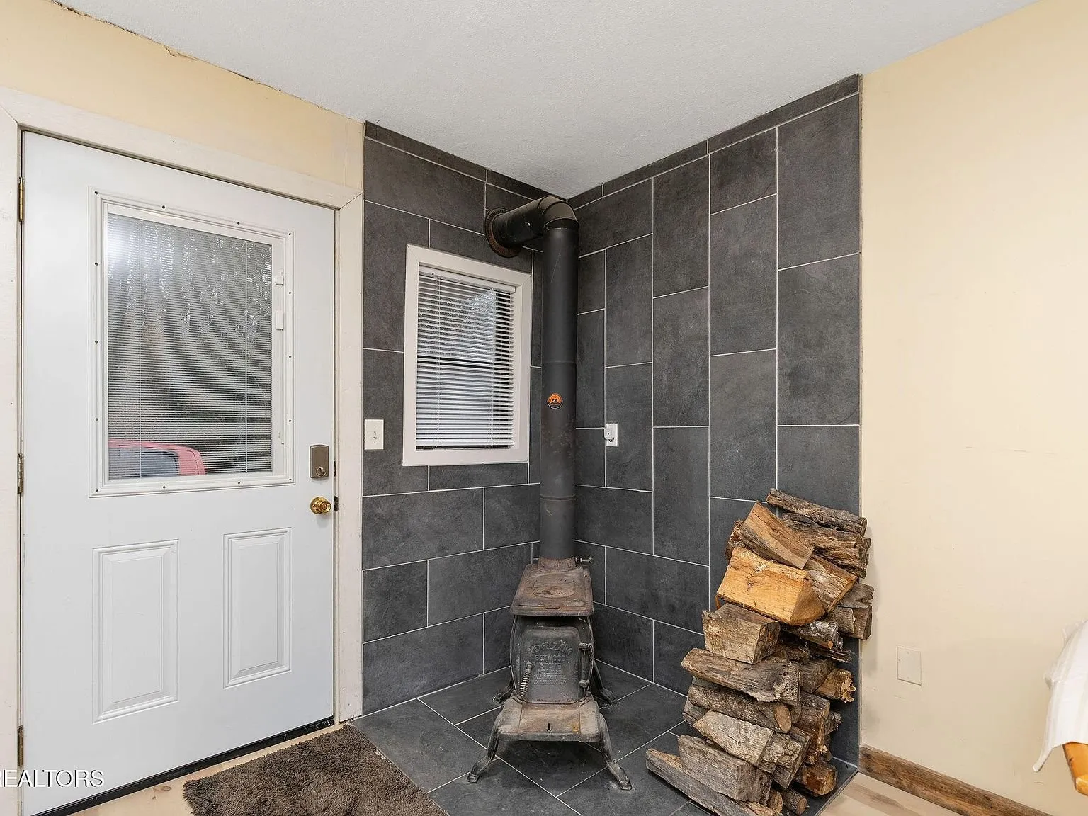 A closer view of the tiled shower and shelving in the bathroom