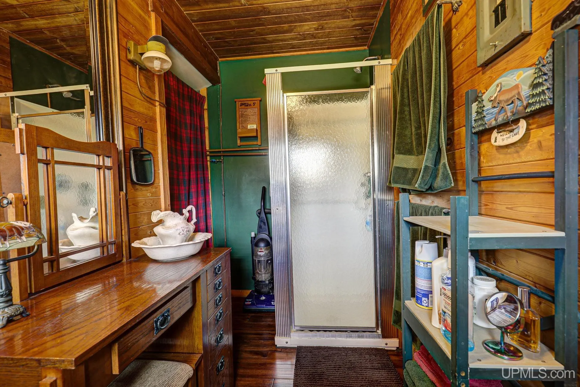 The shower stall and sink in the bathroom