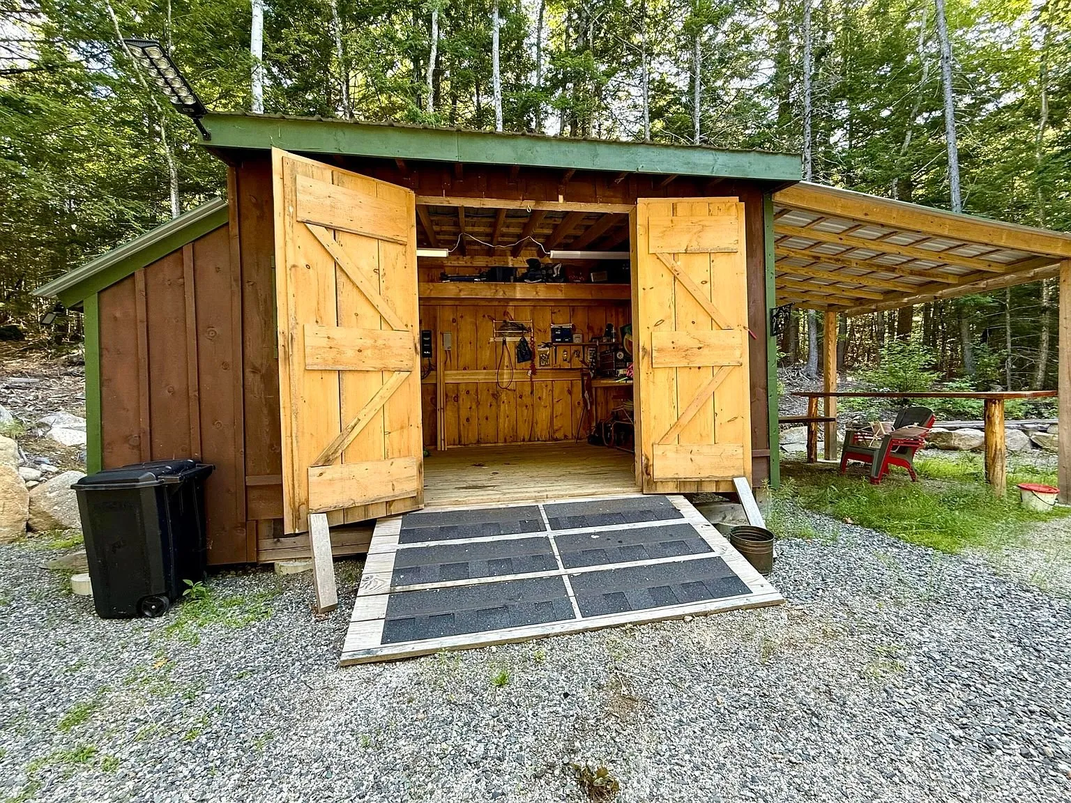 The new shed with its doors open, a lean-to on each side and the ramp