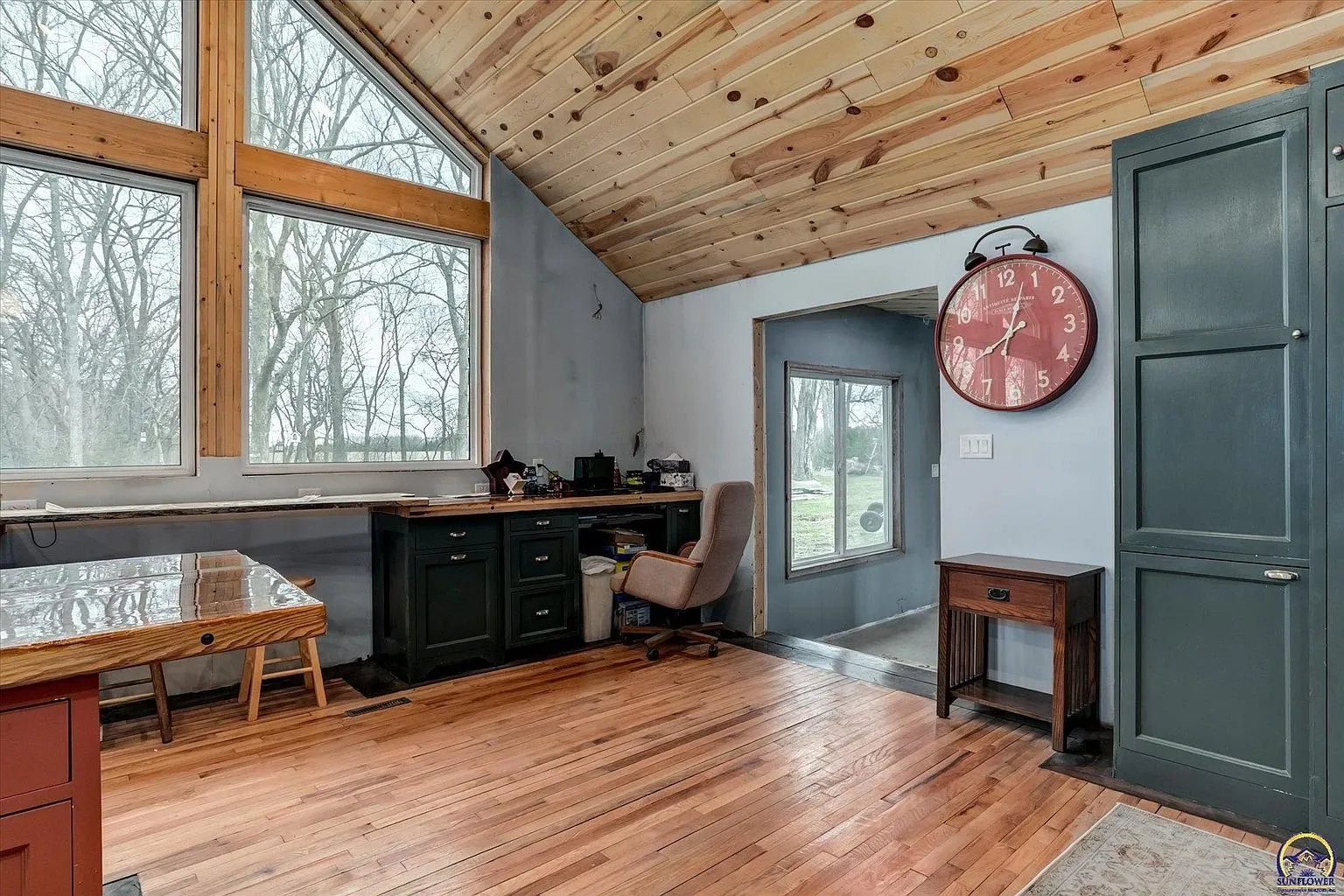 The kitchen toward the doorway with the clock and the built-in cabinet
