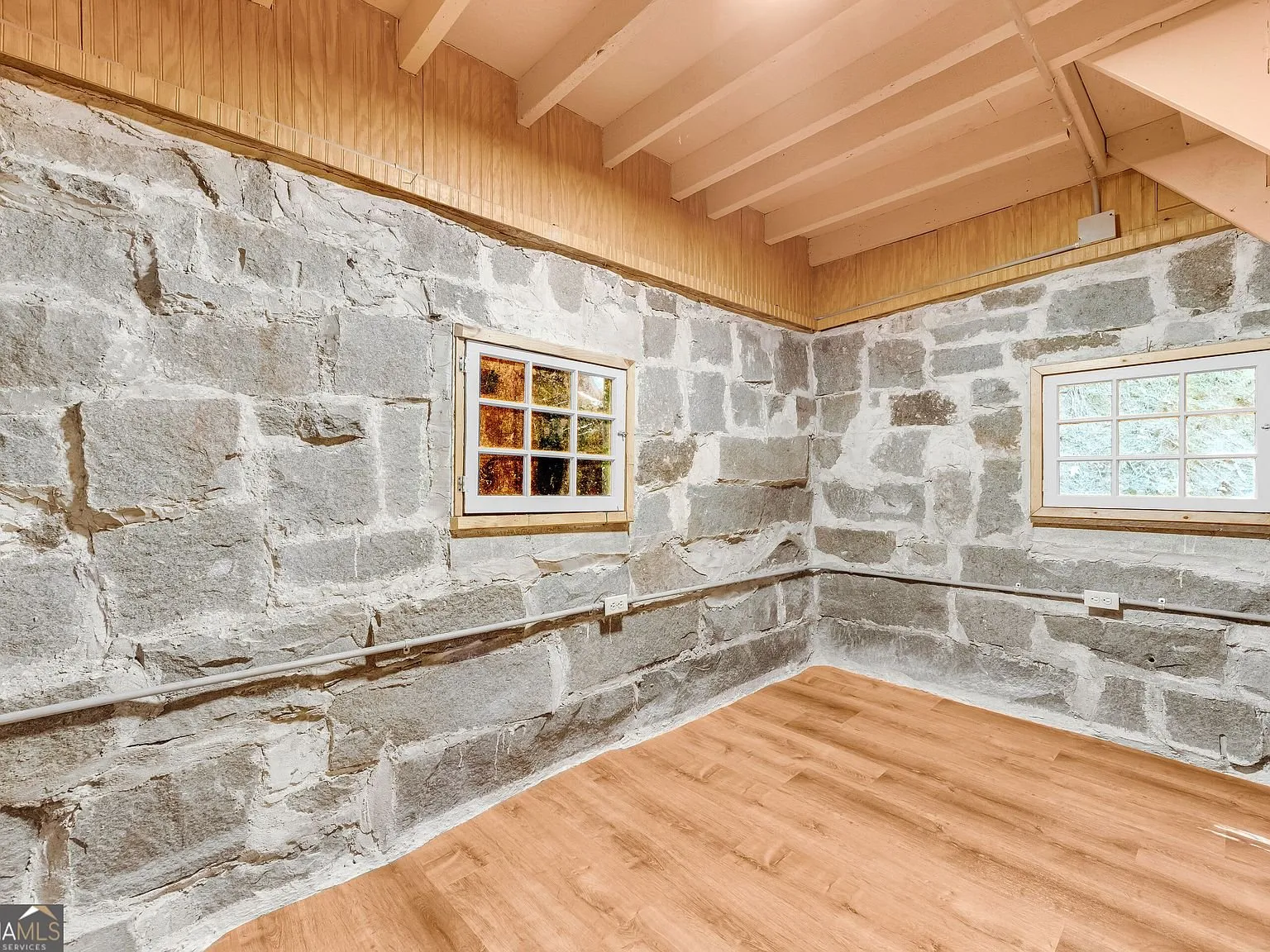A wood-paneled upstairs room under the roofline