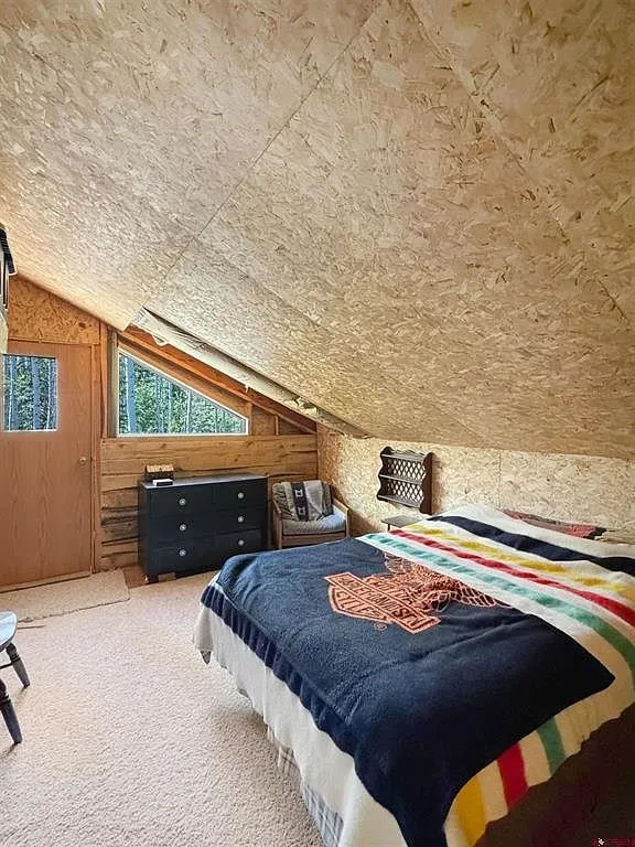 A loft bedroom with the bed under the window