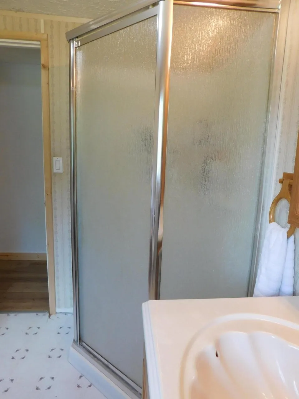 The shower stall with a glass door in the bathroom