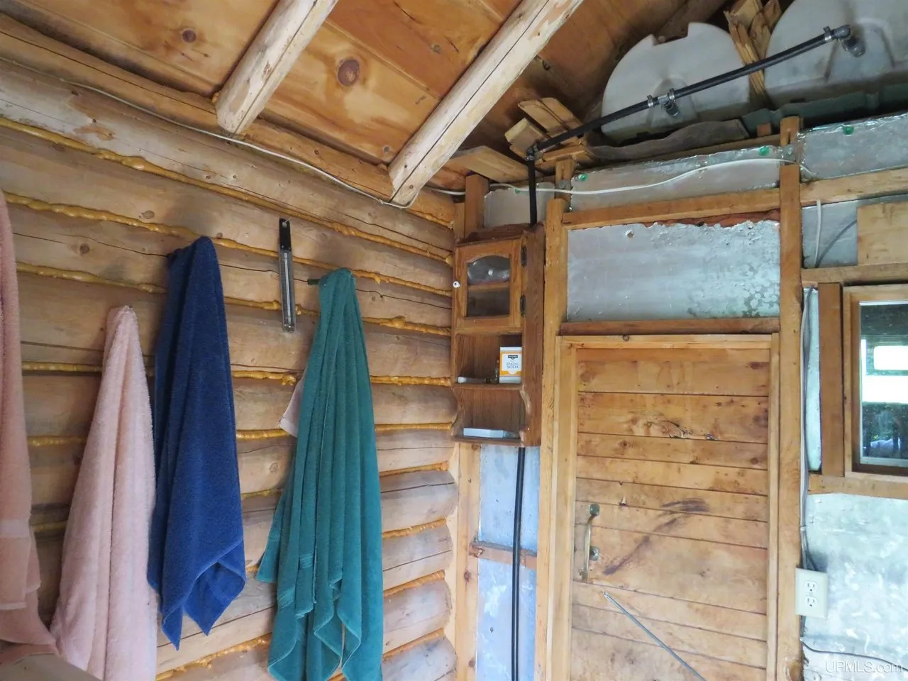 Towels hanging in the sauna's shower area