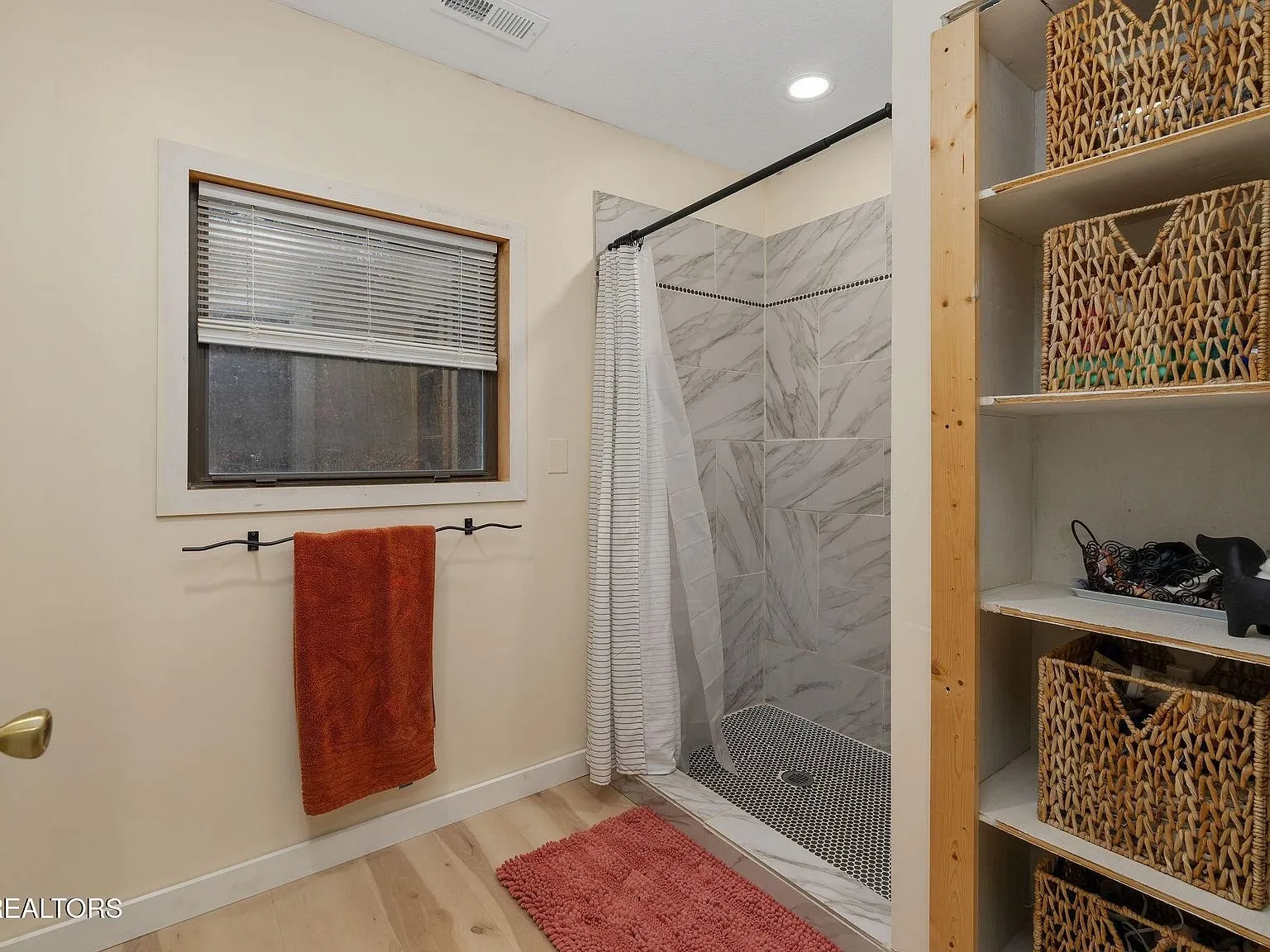 The washer and dryer in a laundry nook with open shelving