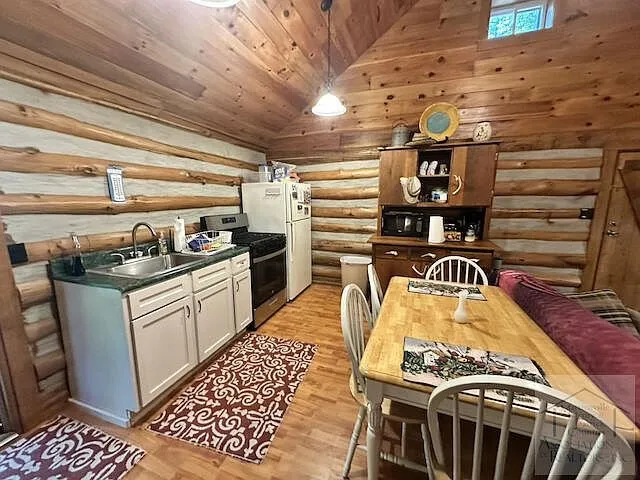 The kitchen counter and dining table under the log walls
