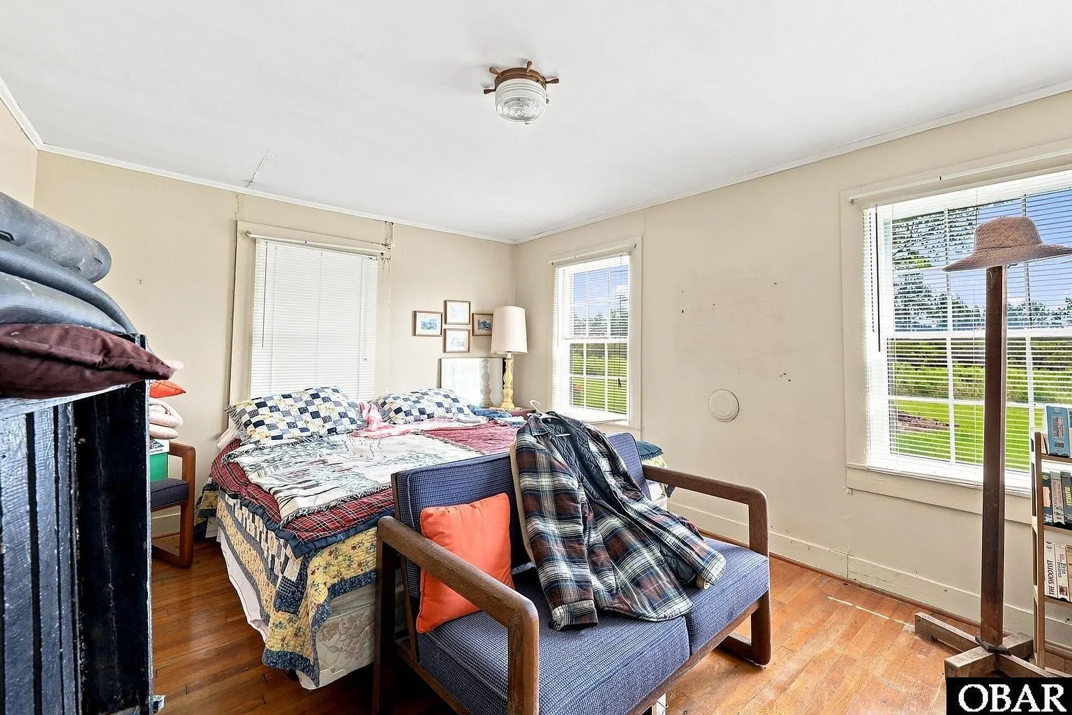 An upstairs bedroom with a bed and a window