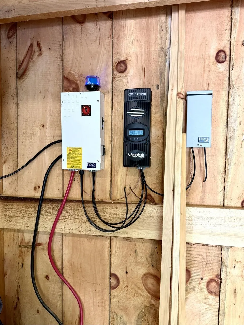 The solar charge controller and the inverter on the wall