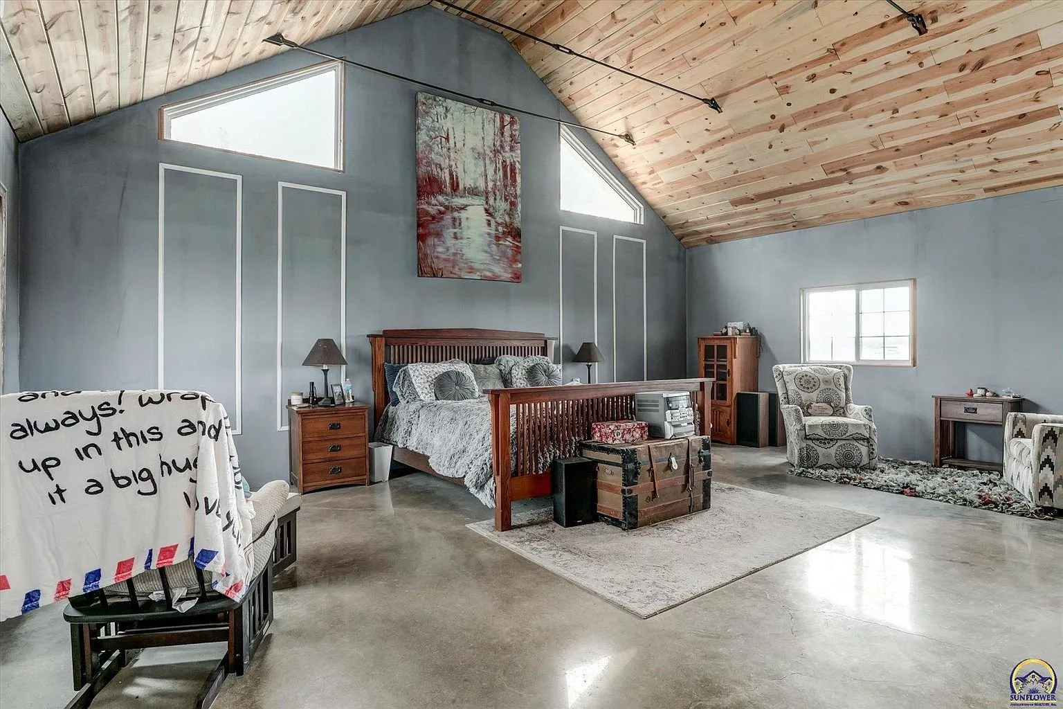 The primary bedroom in the addition with the pine ceiling and the bed