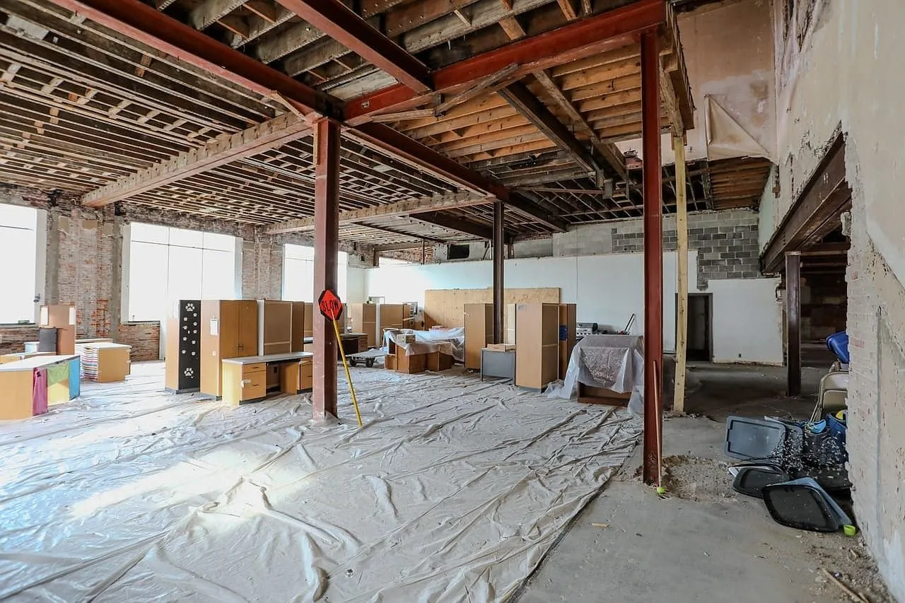 The long ground floor room with the steel column and the exposed ceiling