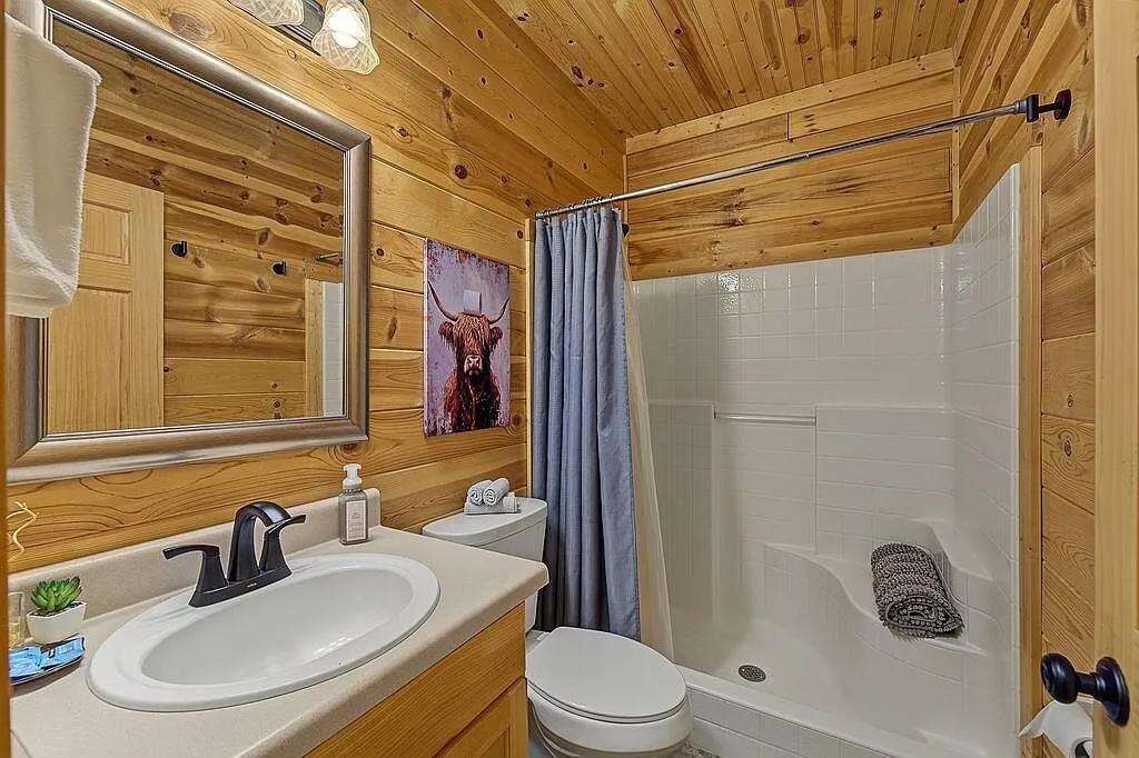 A pedestal sink bathroom with a window and towel bar