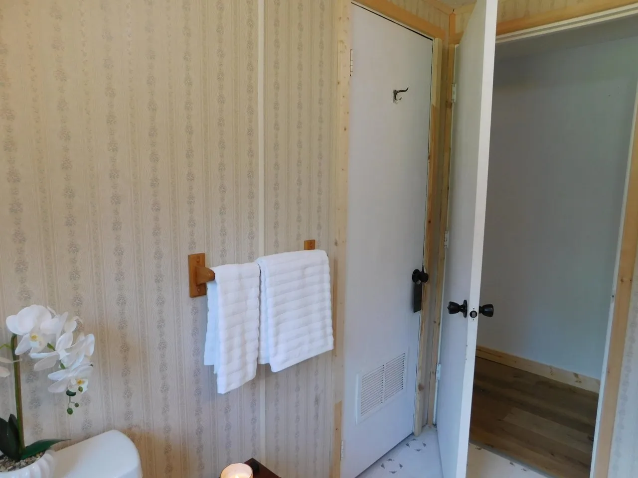 The bathroom doorway and towel rail