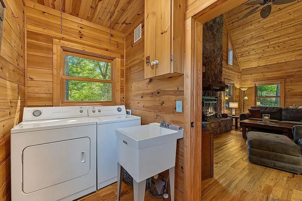 The laundry area with a washer and dryer along the wall