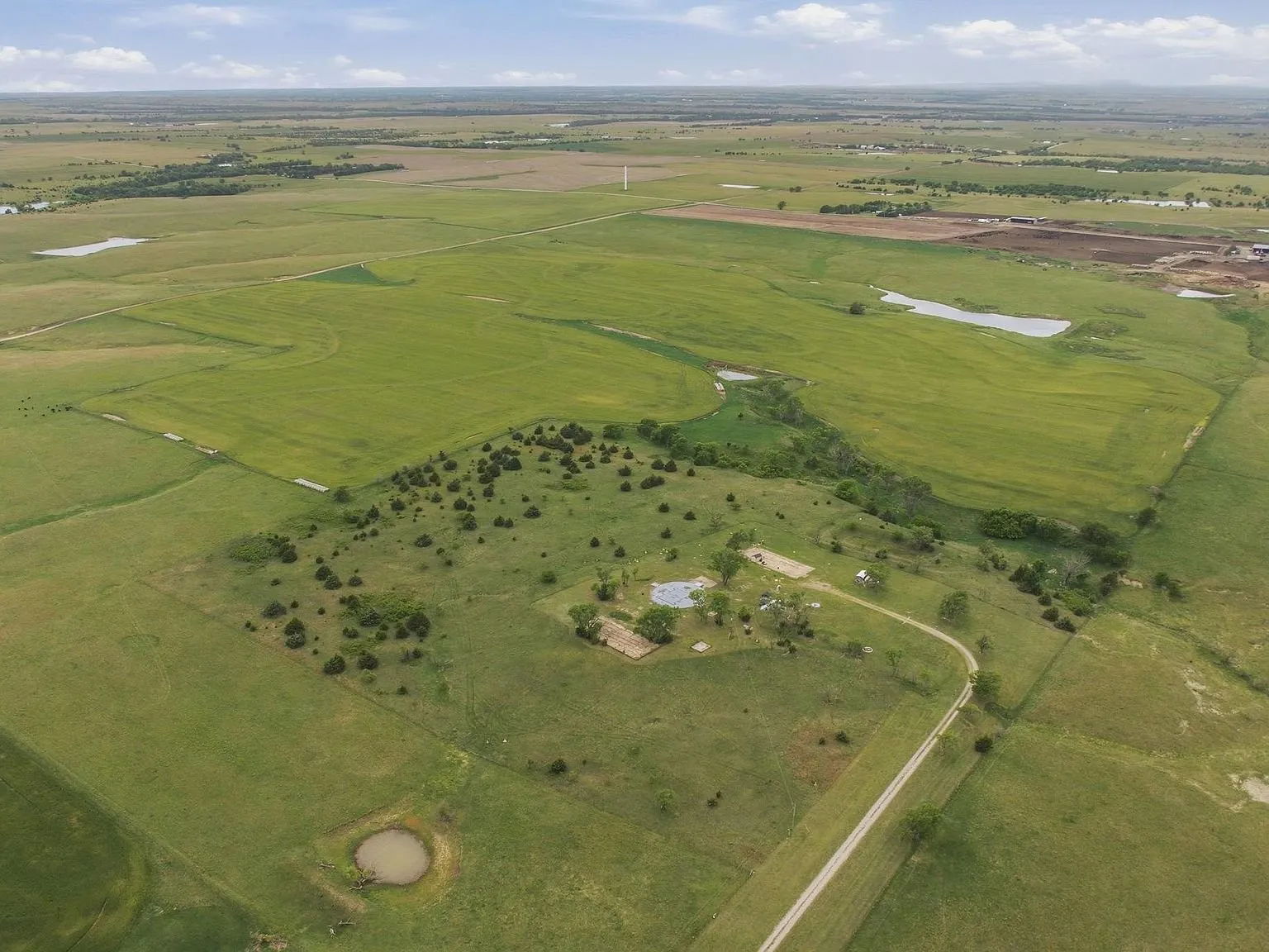 Another wide aerial view showing the property's position within the open countryside