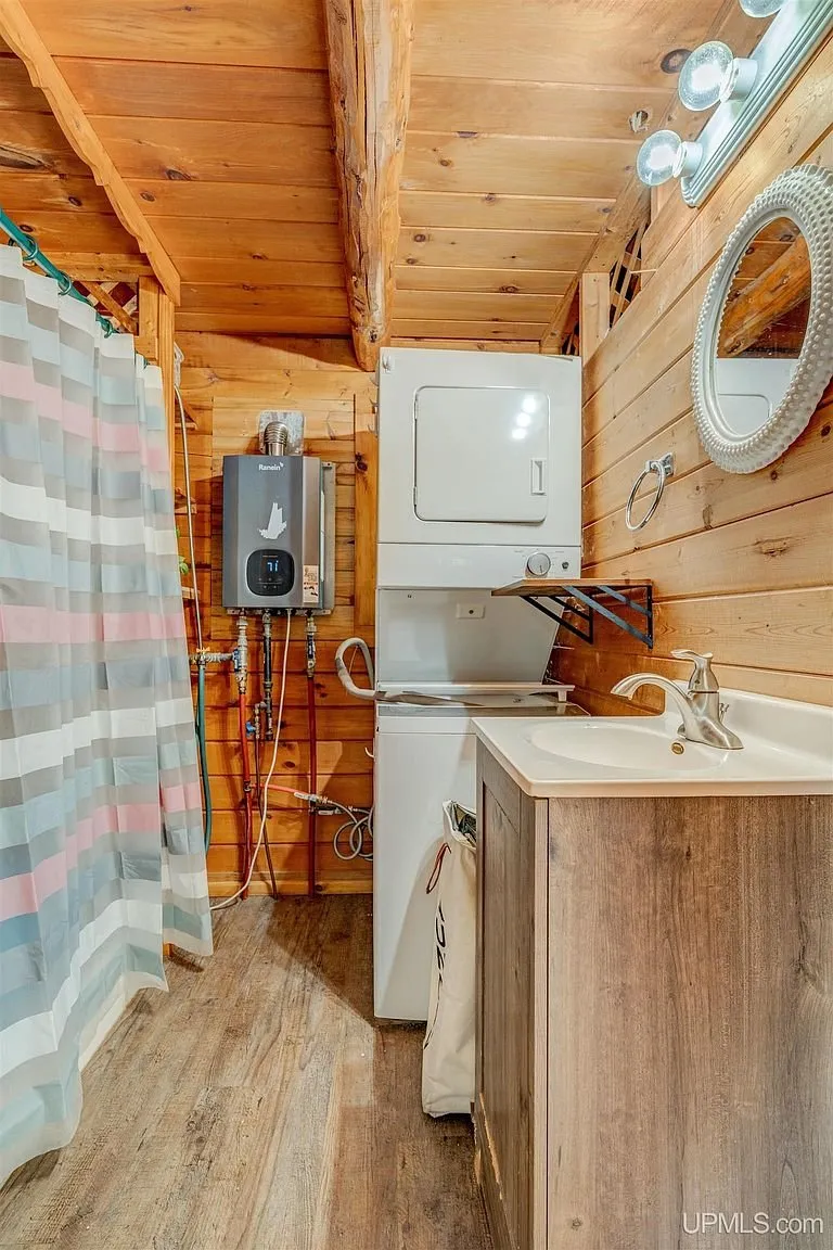 The bathroom vanity, tankless water heater and the stacked washer and dryer