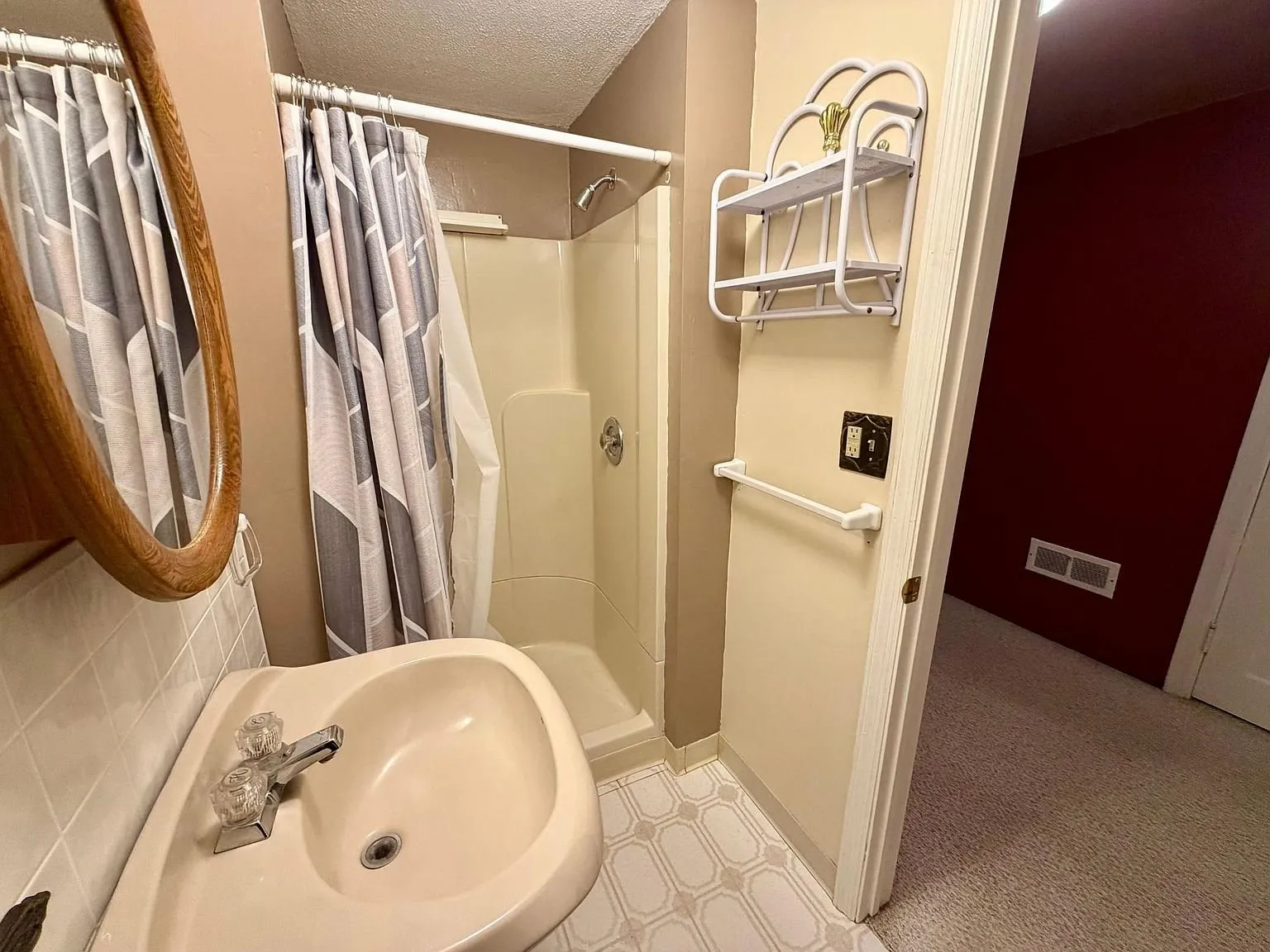 The second bathroom with the shower stall and the pedestal sink