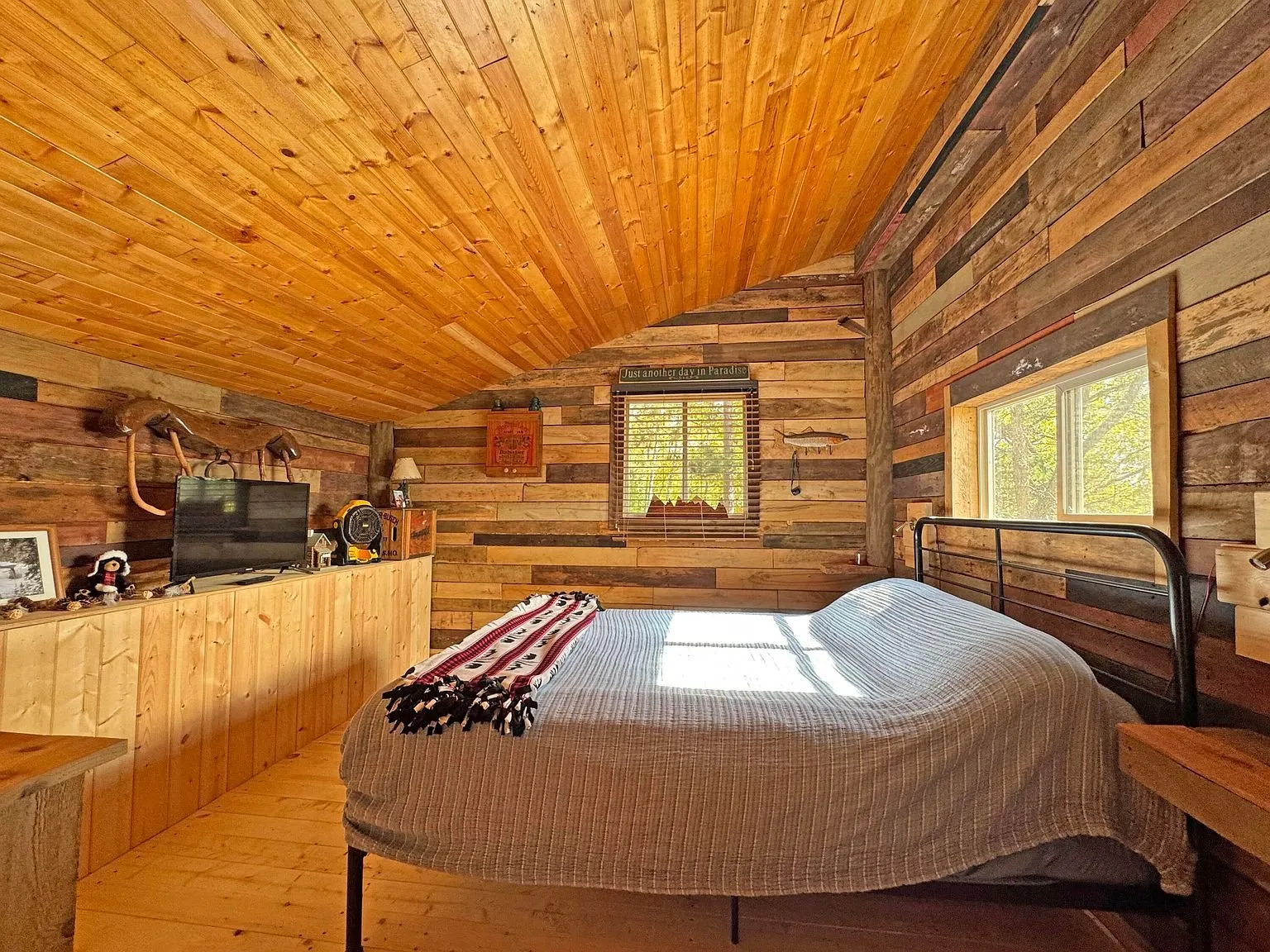 The loft bedroom under the roof, bed beneath the window