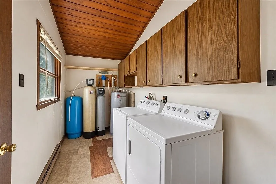 A second bathroom with a tiled shower, toilet and vanity