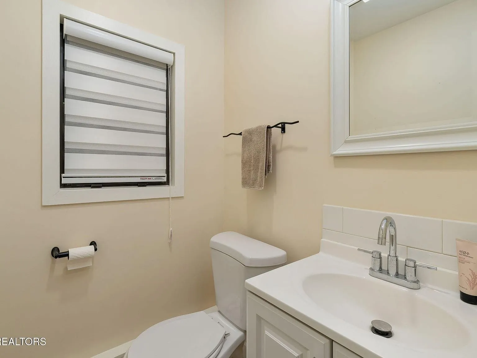 A hallway leading past a second shower into a bedroom