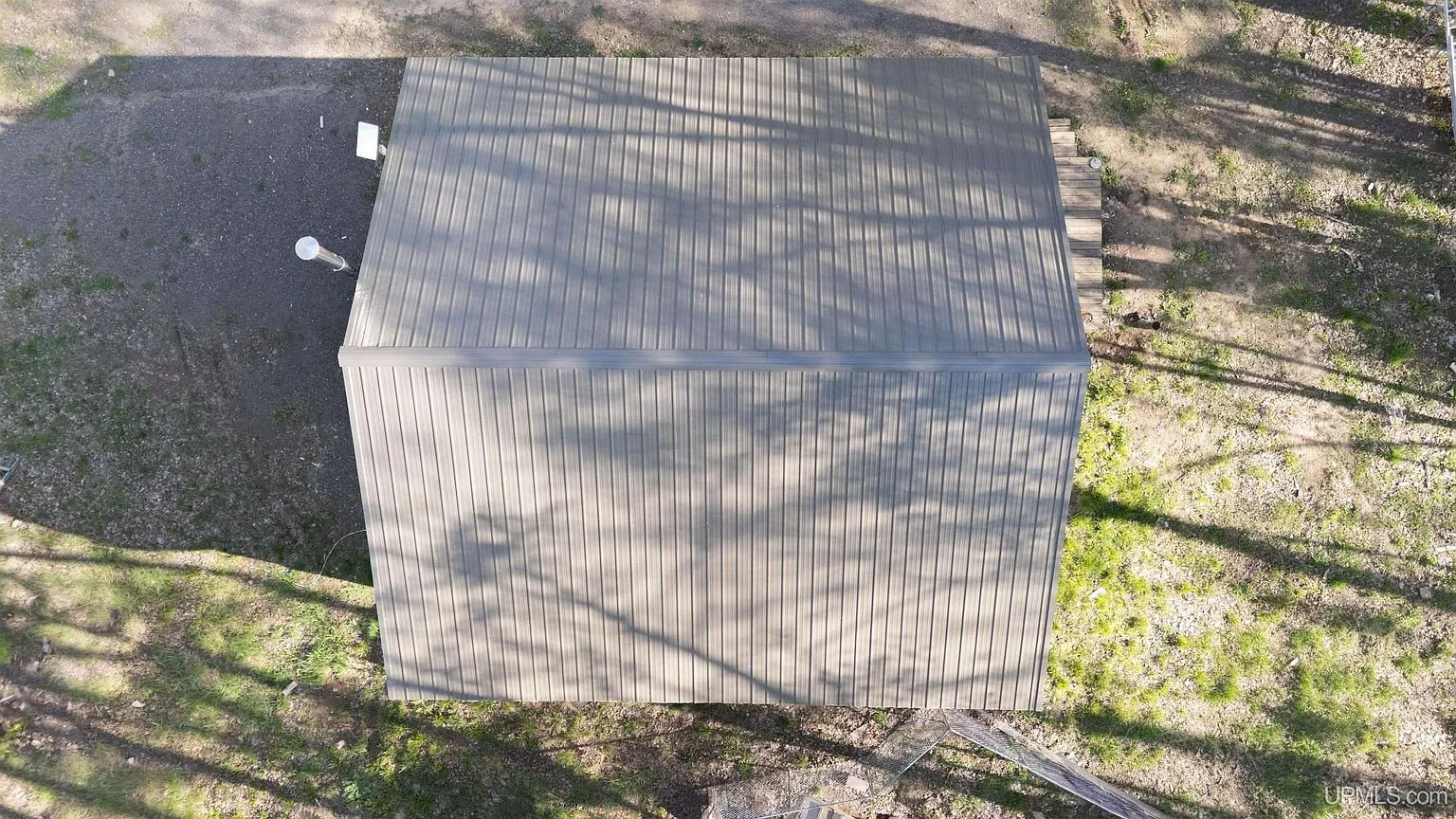 The metal roof and the gravel yard from directly above