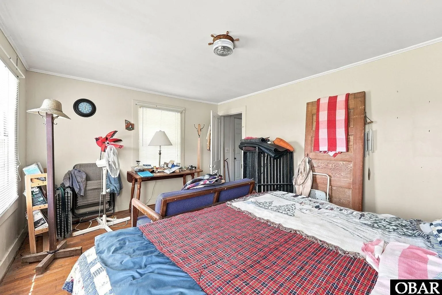 An upstairs bedroom with a quilt on the bed