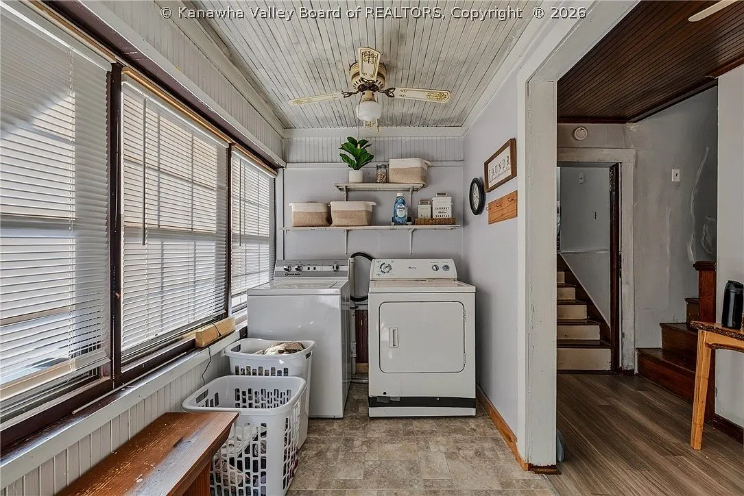 The sunroom laundry area with washer, dryer and built-in shelving