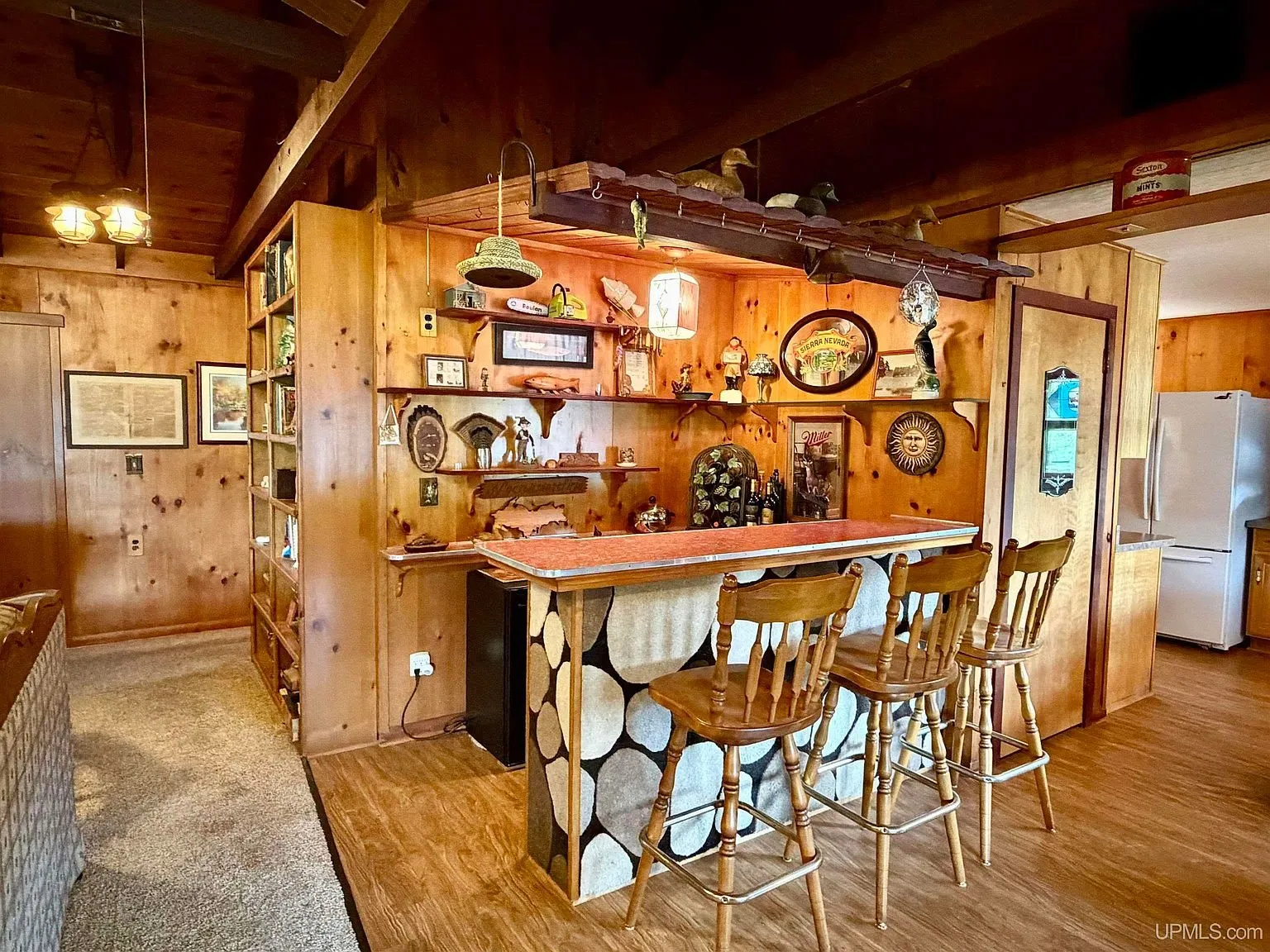 The wet bar with its log-slice front and stools