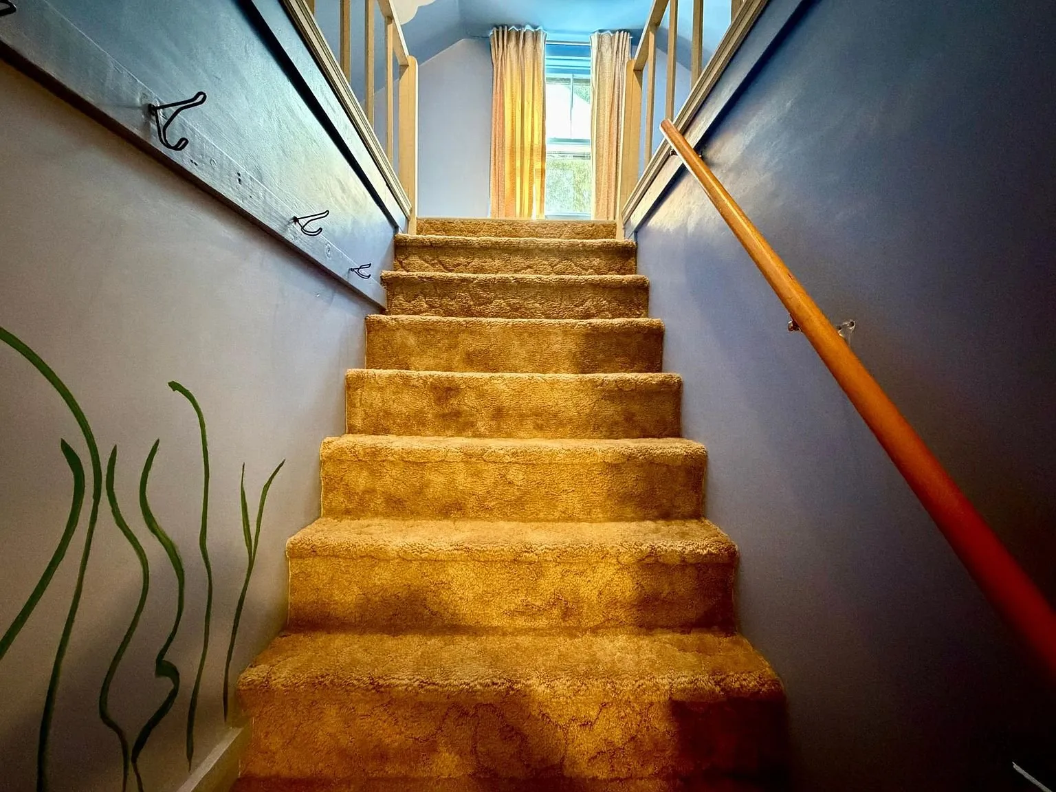The carpeted stair up to the second floor