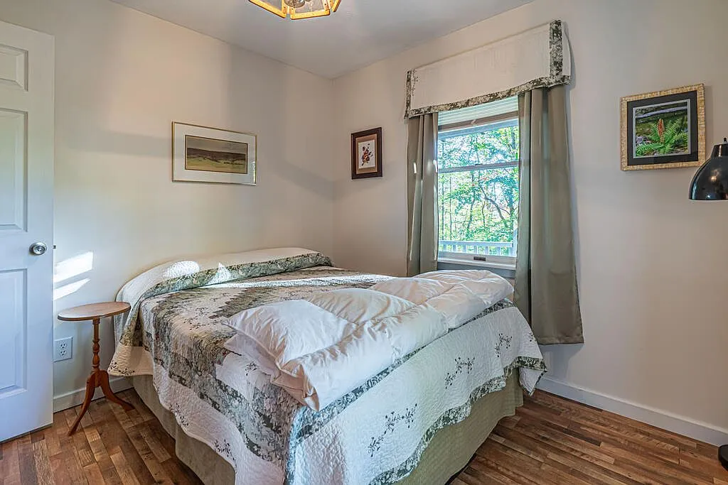 The primary bedroom's dresser and doorway into the hall