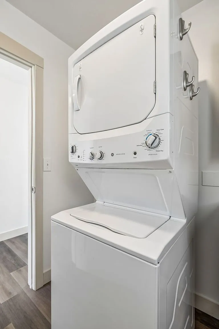 The stacked washer and dryer in the hall