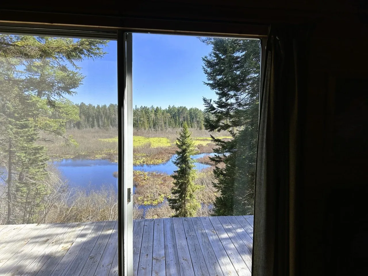 The view out the sliding door to the deck and the water