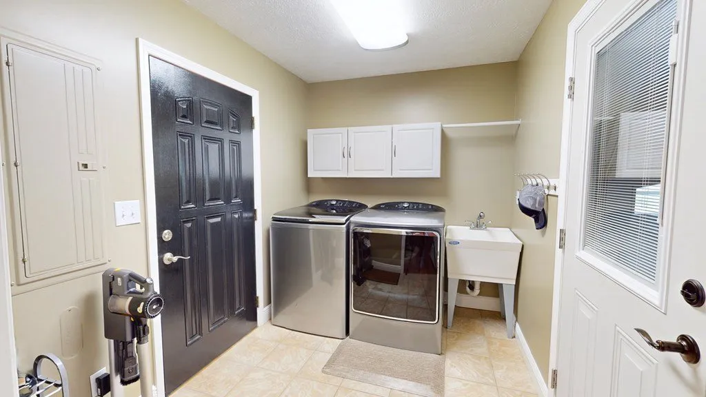 The laundry room with a washer, dryer and cabinets