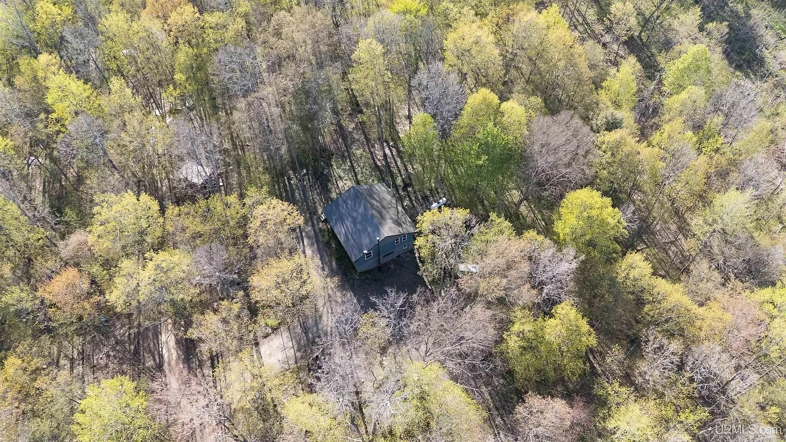 The cabin from high above with the woods around it