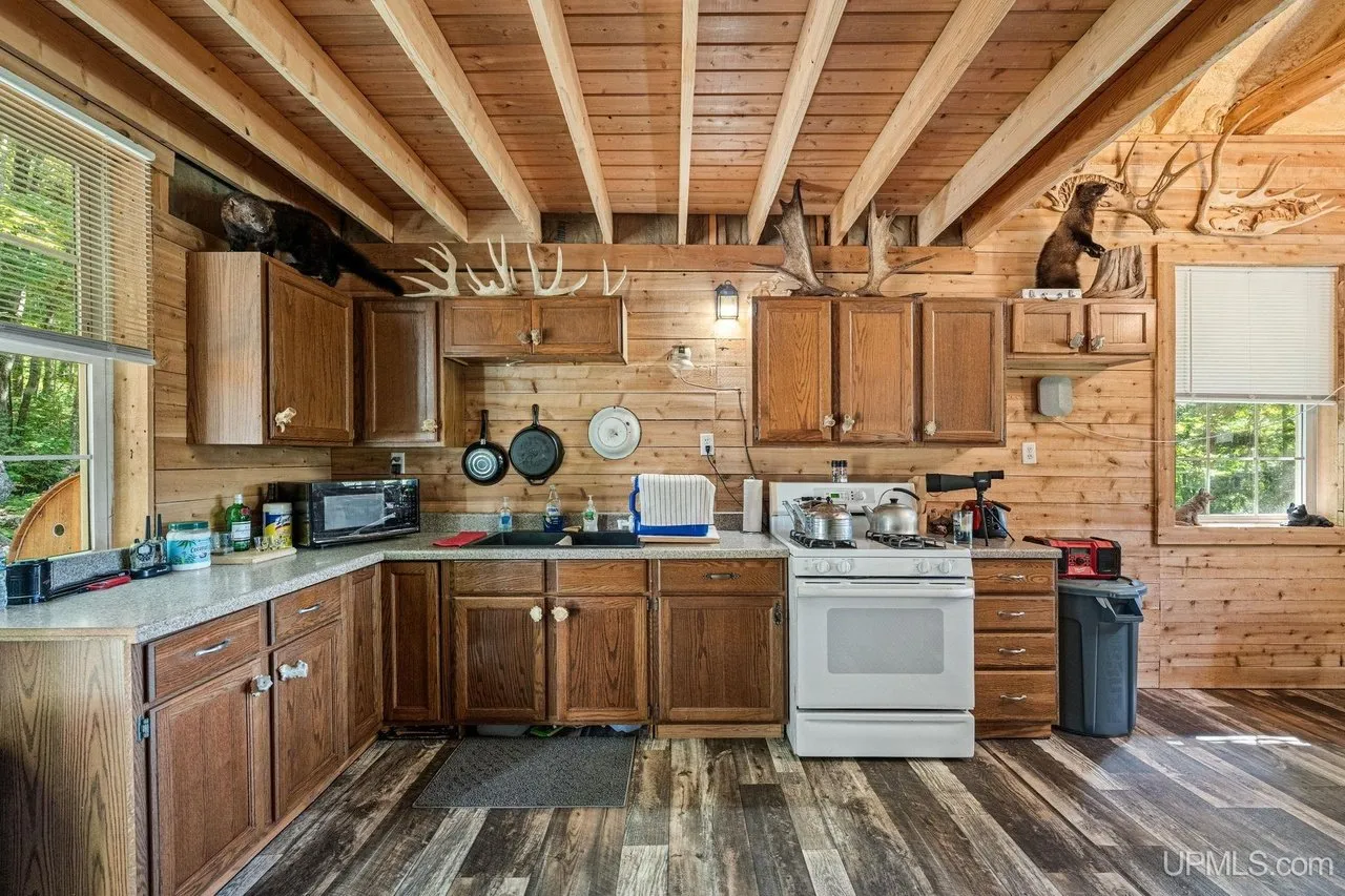 The kitchen along the wall with counters and cabinets