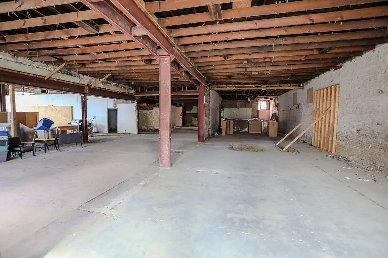 The ground floor looking toward a framed partition and the far windows