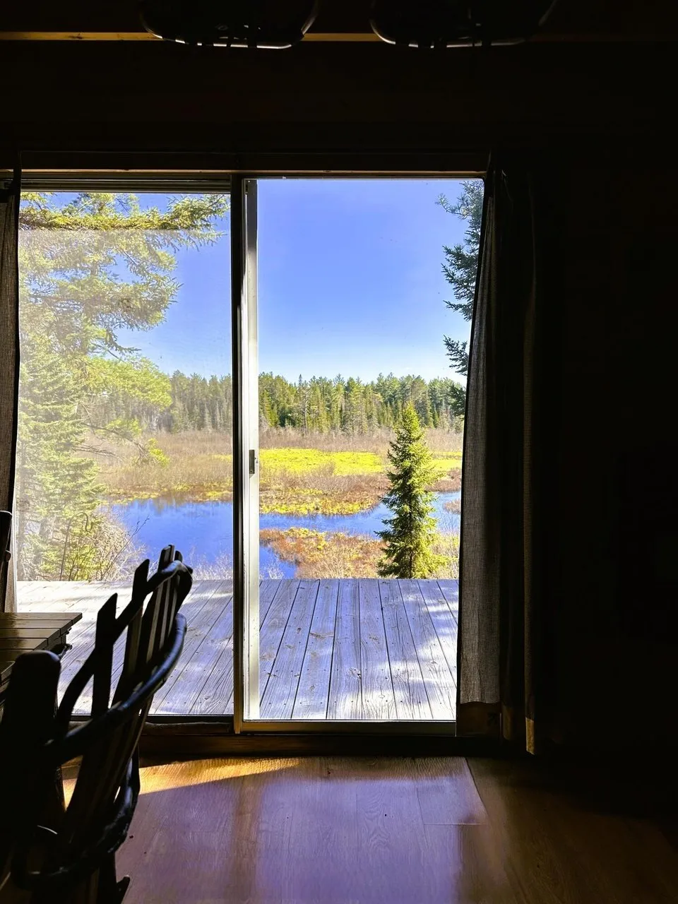 The open door onto the deck with the river beyond