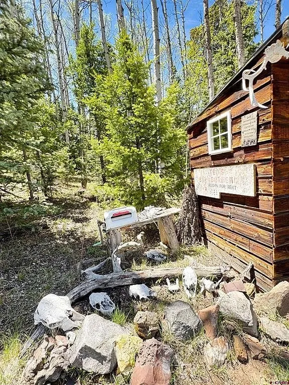 The second cabin with its log front and the stacked wood