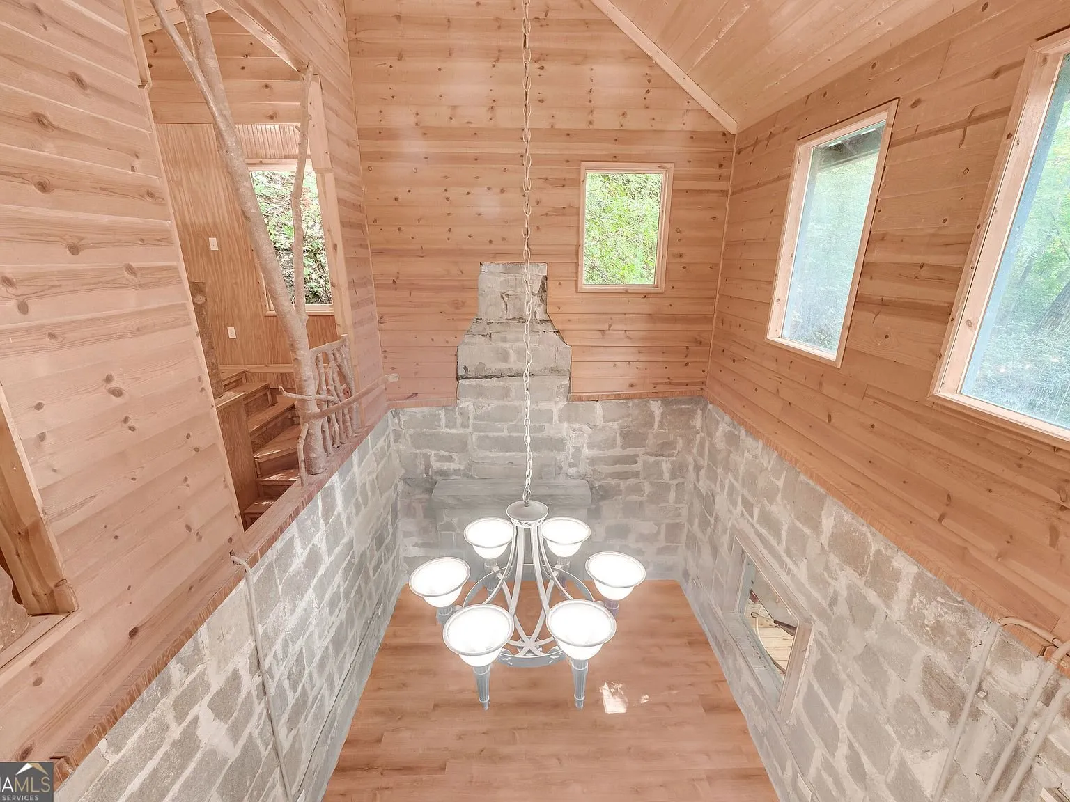 An upstairs room with French doors leading out to a deck