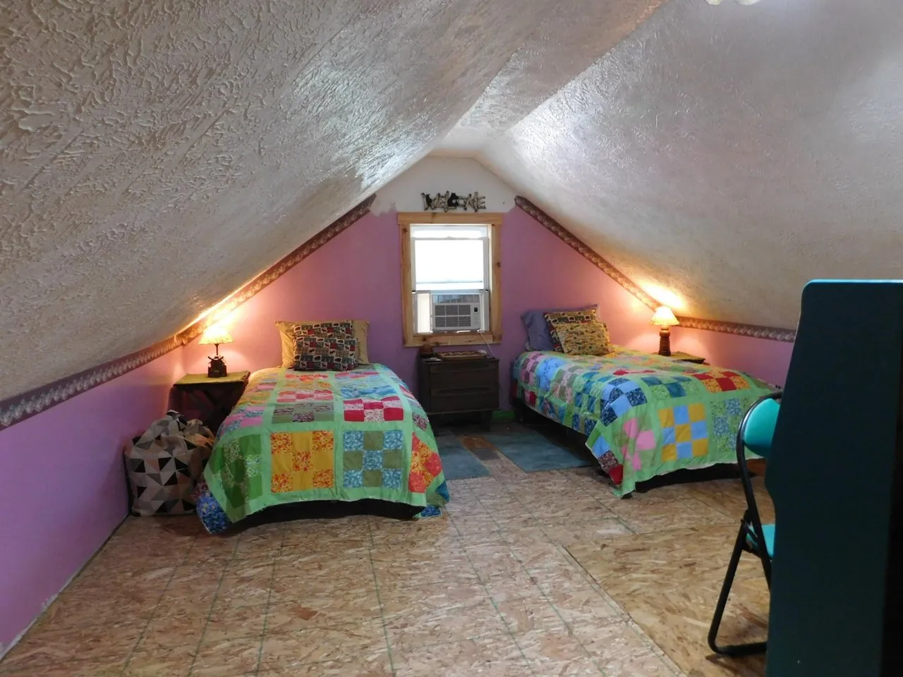 The loft set up with two beds under the peak