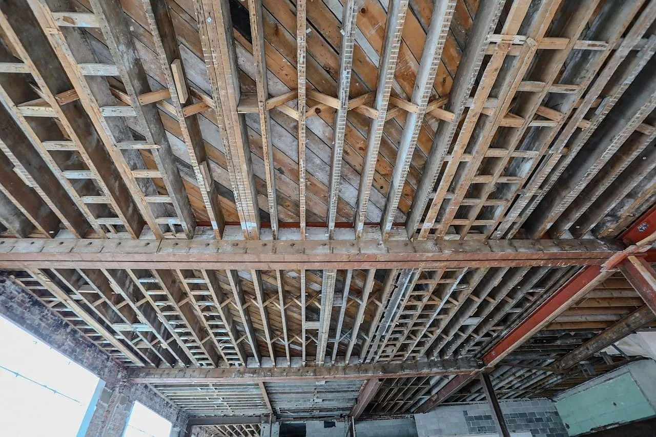 The wood joists and subfloor overhead where the ceiling was removed