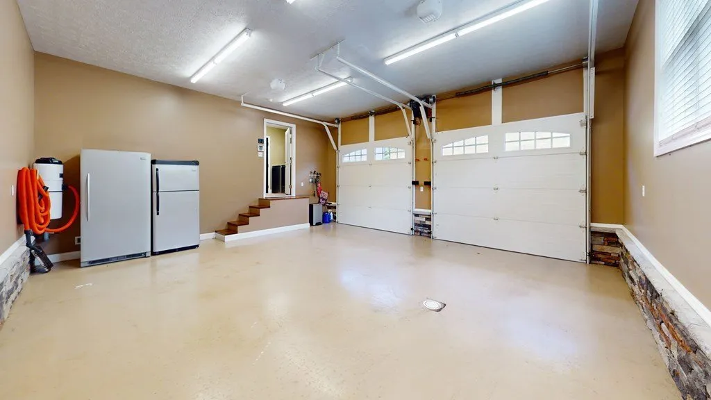 The attached garage interior with an extra refrigerator