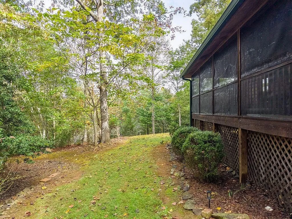 The rear yard and screened porch seen across the lawn