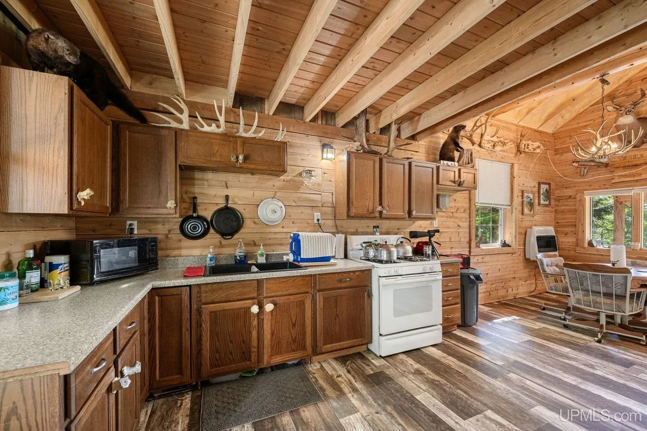 The kitchen from the other end with the range and microwave