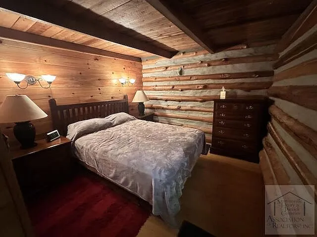 The main level bedroom with a bed and dresser