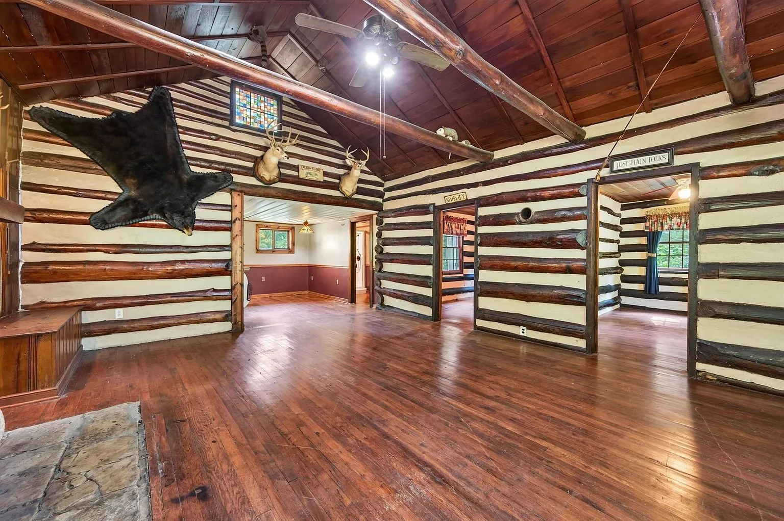 The family room with its log walls and wood floor