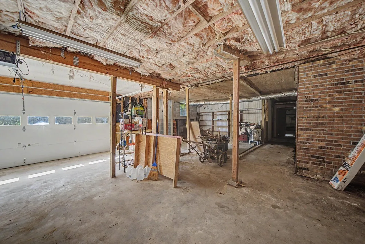 The basement from the other end, brick wall and the garage doors beyond