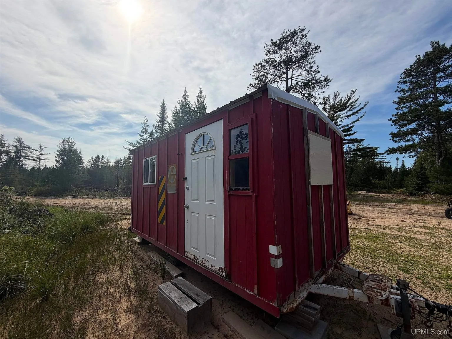 The red shack from the door end with the trailer frame beneath it